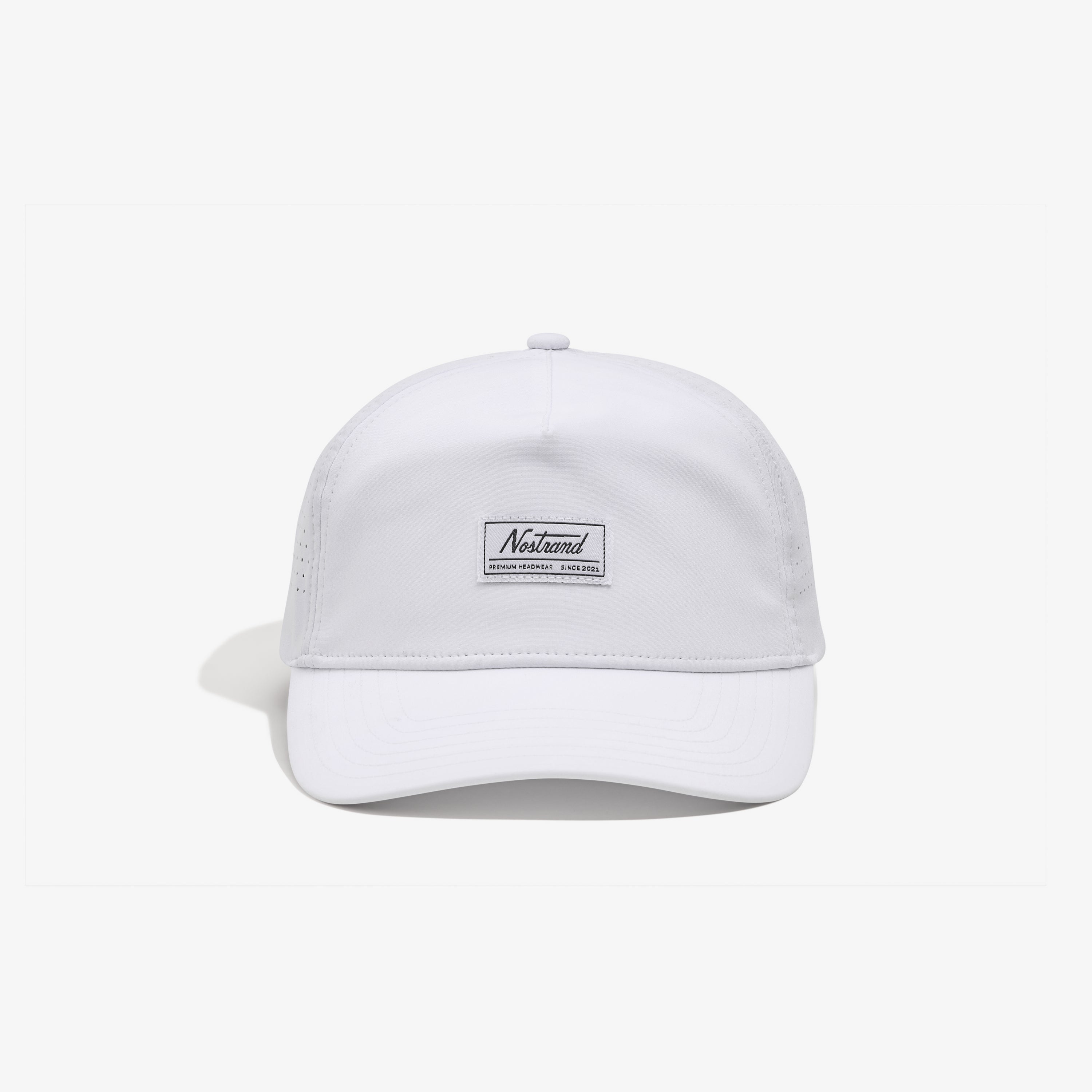 White baseball cap, front view, patch reading Nostrand and PREMIUM HEADWEAR SINCE 2021