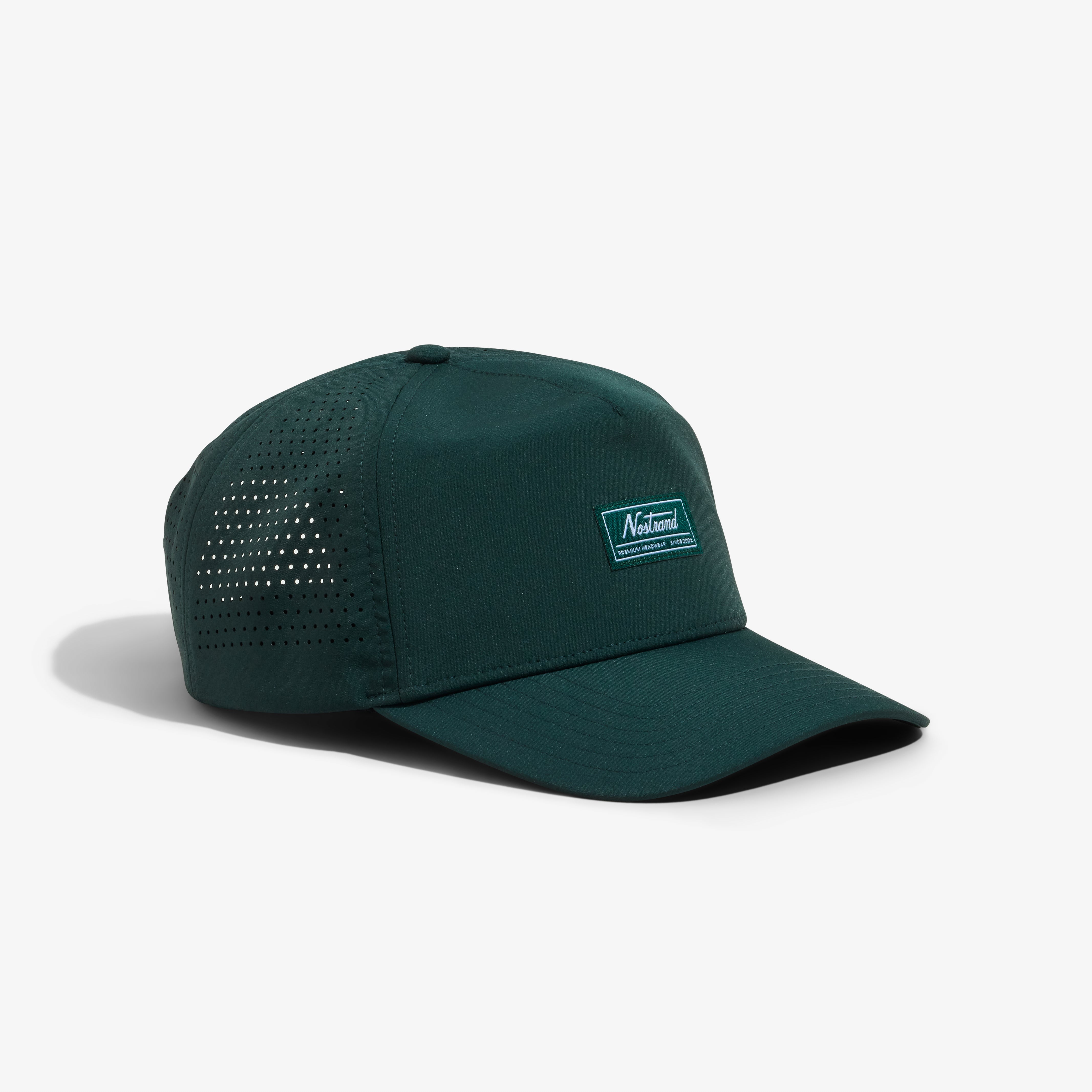 Dark Green athletic baseball cap with perforated side panels, mesh insert behind front panel, semi-curved brim, and small rectangular brand logo woven label on front of hat - Daily Tech Hat Dark Green